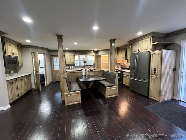 kitchen with stainless steel appliances, ornate columns, premium range hood, and dark wood-type flooring