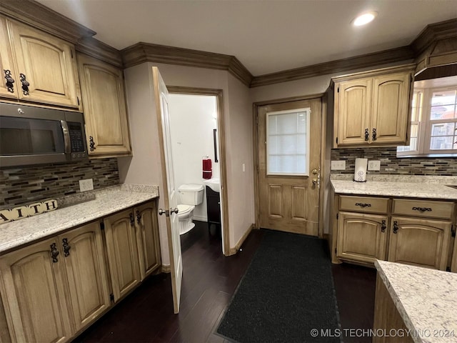 kitchen with light stone countertops, tasteful backsplash, crown molding, and dark wood-type flooring