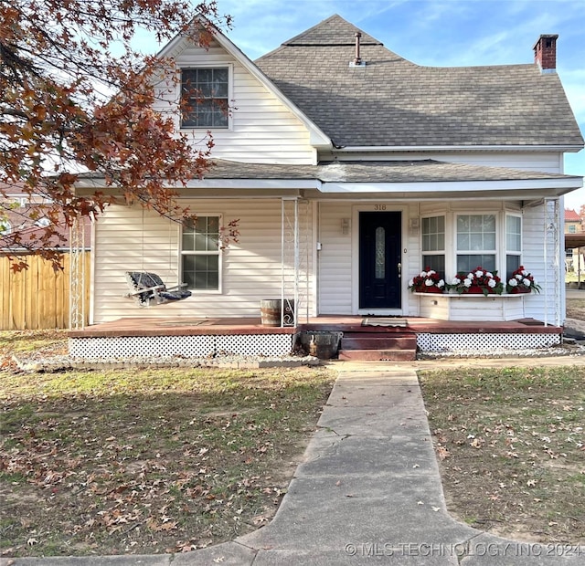 view of front of home with a porch and a front yard