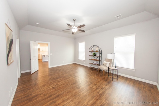 unfurnished room featuring dark hardwood / wood-style flooring, vaulted ceiling, and ceiling fan