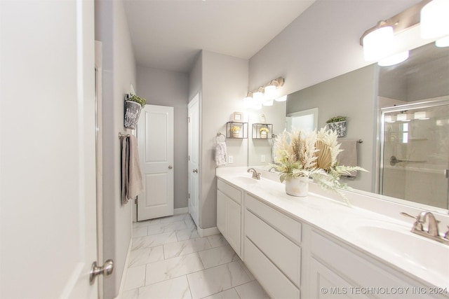 bathroom with vanity and a shower with shower door