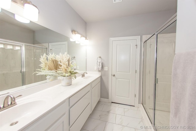 bathroom with vanity and a shower with door