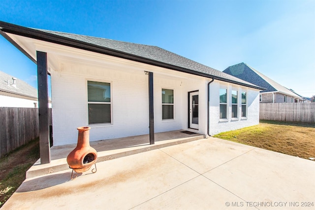 rear view of property featuring a patio area