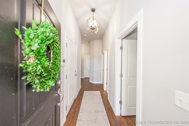 doorway to outside featuring dark wood-type flooring and a notable chandelier