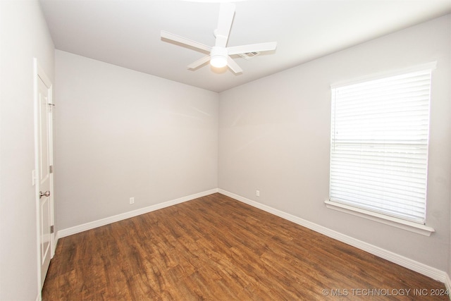 spare room with ceiling fan and dark hardwood / wood-style flooring