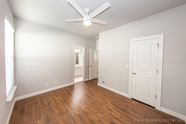 spare room featuring plenty of natural light, ceiling fan, and dark wood-type flooring