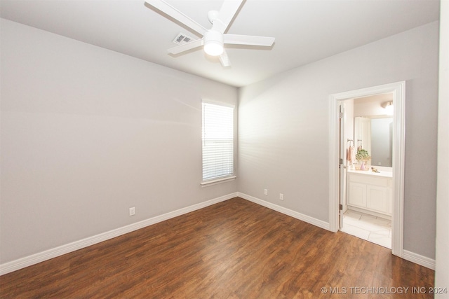 spare room with dark hardwood / wood-style flooring and ceiling fan