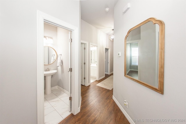 corridor featuring hardwood / wood-style flooring and sink