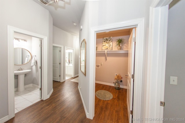 hallway featuring dark wood-type flooring and sink