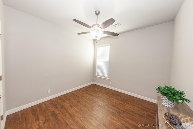 unfurnished room featuring dark hardwood / wood-style floors and ceiling fan