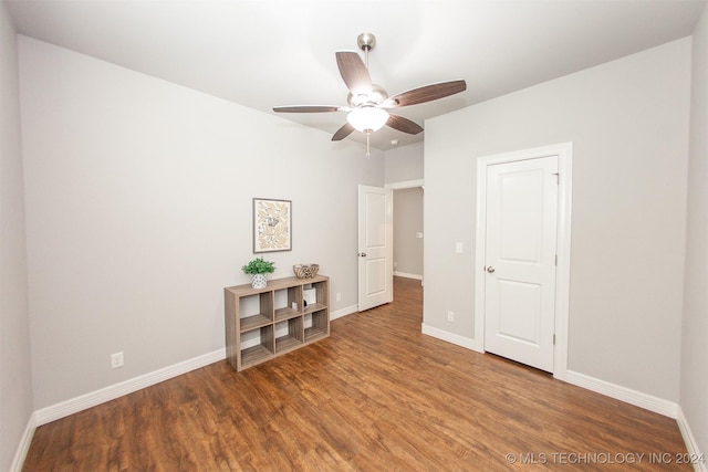 unfurnished room featuring dark hardwood / wood-style flooring and ceiling fan