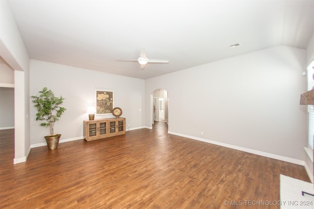 unfurnished living room with ceiling fan and dark wood-type flooring