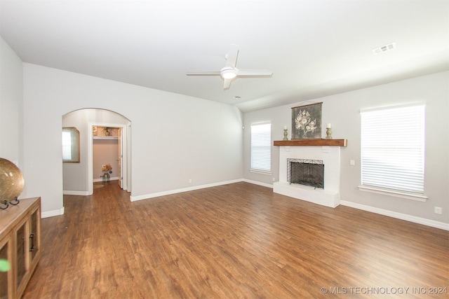 unfurnished living room featuring dark hardwood / wood-style floors, plenty of natural light, and ceiling fan