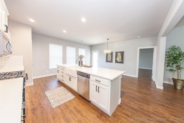 kitchen with dark hardwood / wood-style floors, an island with sink, decorative light fixtures, white cabinetry, and stainless steel appliances