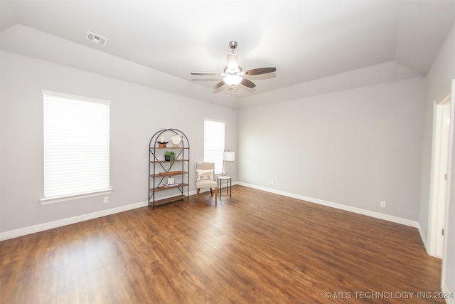 spare room featuring dark hardwood / wood-style floors, ceiling fan, and lofted ceiling