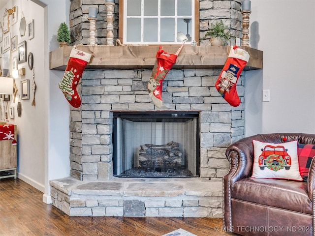 room details featuring hardwood / wood-style flooring and a stone fireplace