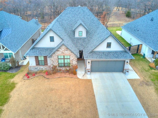 view of front of home with a garage and a front yard