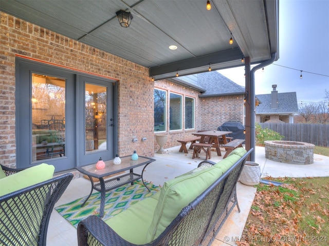 view of patio / terrace with an outdoor living space with a fire pit and a grill