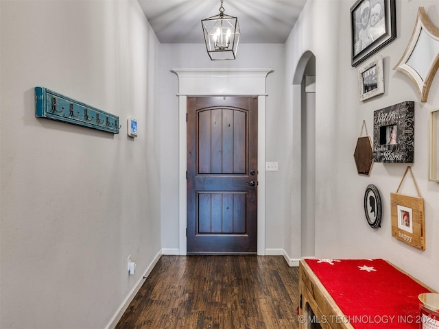 entrance foyer featuring dark hardwood / wood-style floors and a chandelier