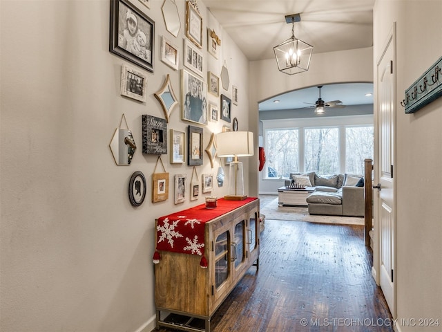 hallway featuring a chandelier and dark hardwood / wood-style floors