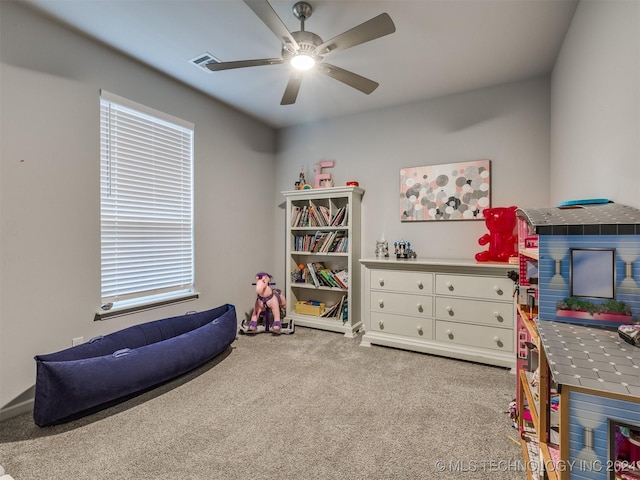 playroom with ceiling fan and light colored carpet