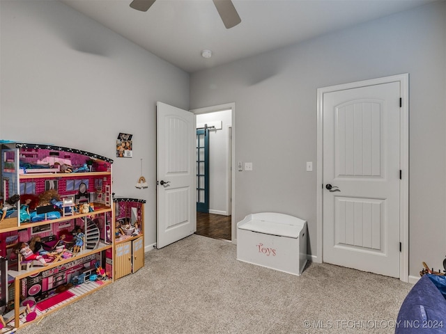 recreation room featuring carpet and ceiling fan