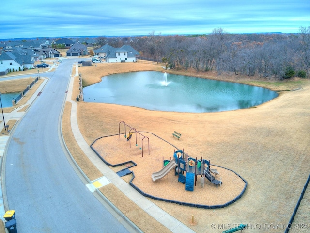 view of pool featuring a playground and a water view