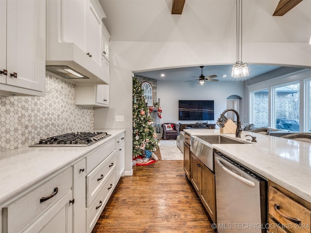 kitchen featuring white cabinetry, hanging light fixtures, appliances with stainless steel finishes, and dark wood-type flooring