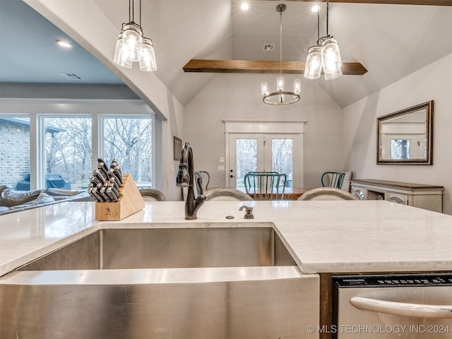 kitchen with pendant lighting, stainless steel dishwasher, sink, and vaulted ceiling