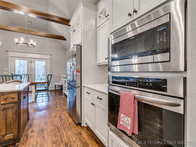 kitchen featuring white cabinets, lofted ceiling with beams, and appliances with stainless steel finishes