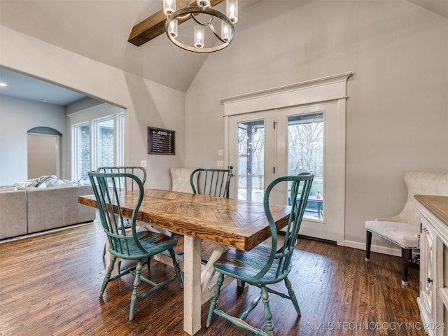 dining room with lofted ceiling, dark hardwood / wood-style flooring, a healthy amount of sunlight, and a notable chandelier