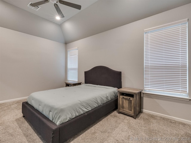 carpeted bedroom with ceiling fan and vaulted ceiling