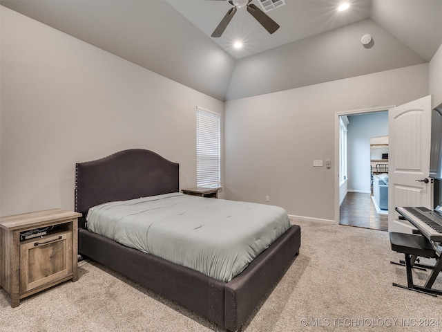 carpeted bedroom with multiple windows, ceiling fan, and vaulted ceiling