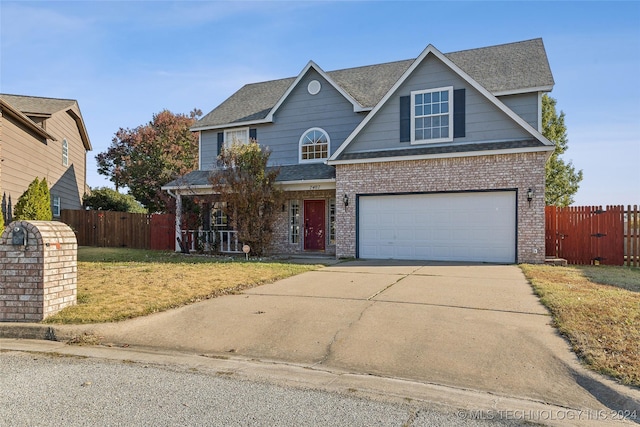 view of front of home featuring a garage and a front lawn