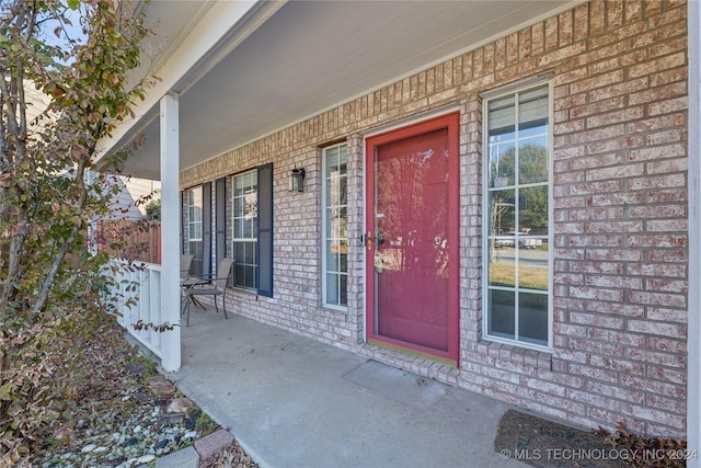 view of exterior entry featuring a porch