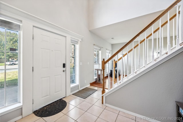 foyer entrance with plenty of natural light and light tile patterned flooring