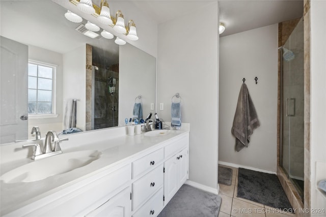 bathroom with tile patterned floors, vanity, and a shower with door