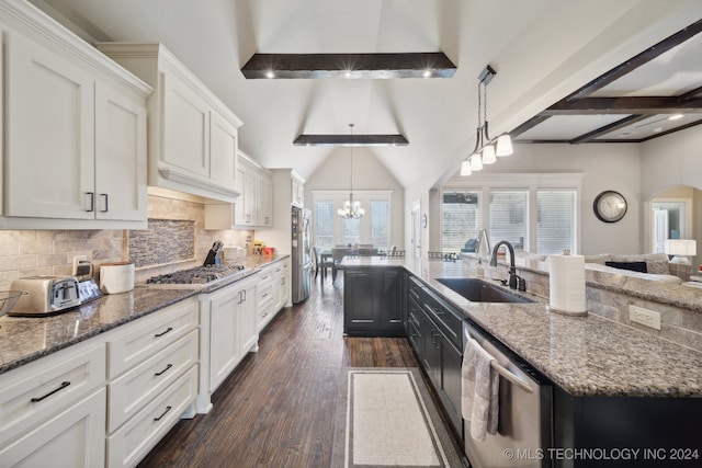 kitchen with dark wood-type flooring, pendant lighting, decorative backsplash, white cabinets, and appliances with stainless steel finishes