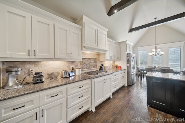 kitchen with dark wood-type flooring, white cabinets, lofted ceiling with beams, tasteful backsplash, and stainless steel appliances