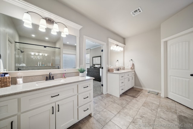 bathroom with a shower with door and vanity