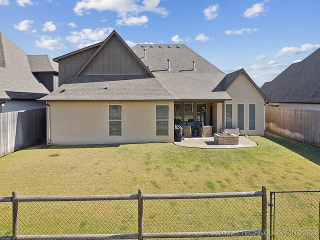 back of house with a patio area and a lawn