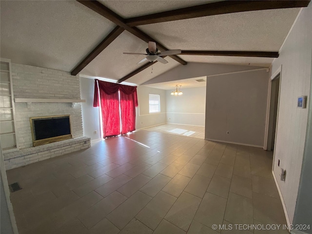 unfurnished living room with a textured ceiling, vaulted ceiling with beams, ceiling fan with notable chandelier, and a brick fireplace