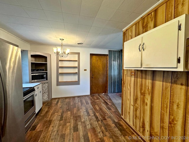 kitchen featuring an inviting chandelier, built in features, appliances with stainless steel finishes, decorative light fixtures, and dark hardwood / wood-style flooring