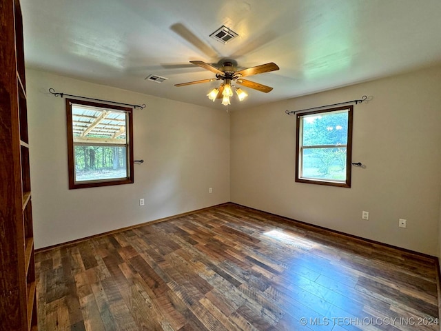 unfurnished room with dark hardwood / wood-style flooring and ceiling fan