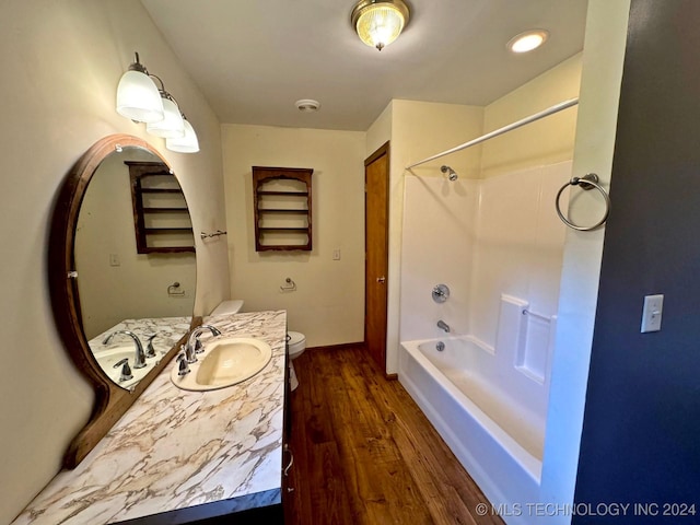 full bathroom featuring hardwood / wood-style floors, vanity, tub / shower combination, and toilet