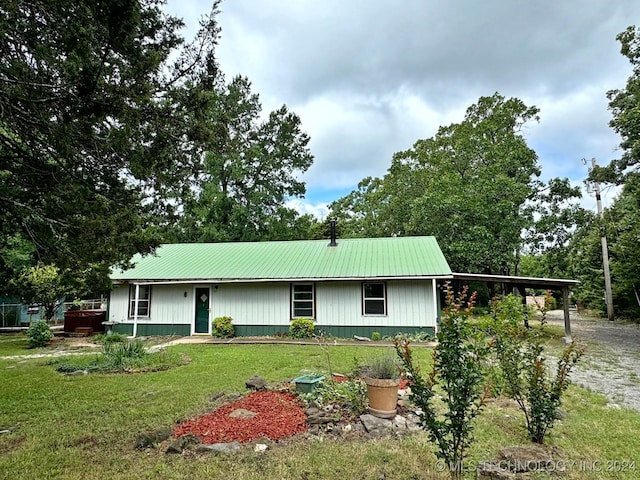 exterior space featuring a carport and a yard