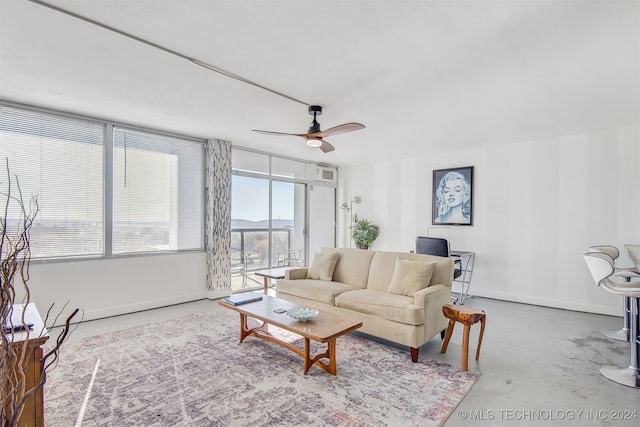 living room with ceiling fan and concrete flooring