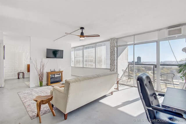 living room featuring a wall mounted air conditioner and ceiling fan