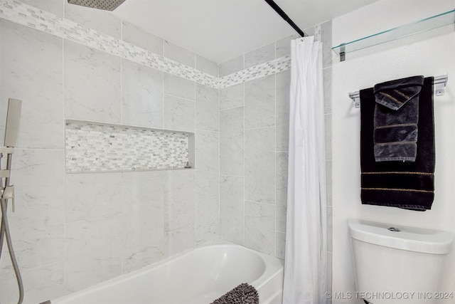 bathroom with shower / bath combination with curtain and toilet