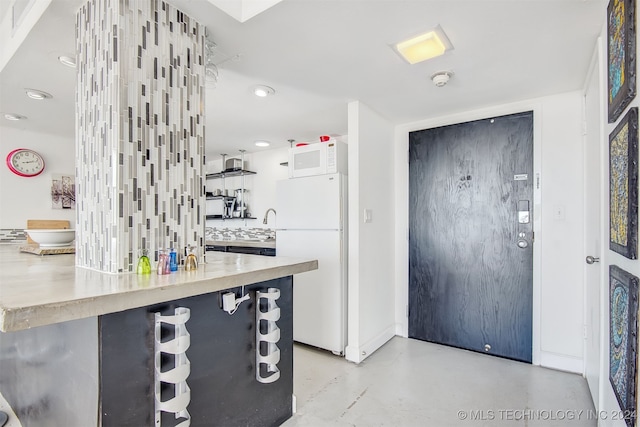 kitchen with tasteful backsplash and white appliances